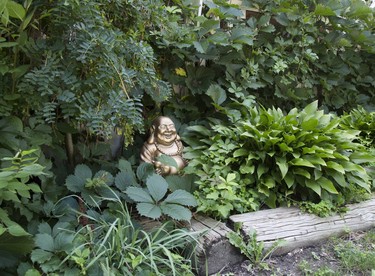 A smiling buddha greets visitors to 585 Maitland St. (Derek Ruttan/The London Free Press)