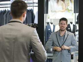 San Jose Shark star player and London native Logan Couture tries on a tuxedo at Collins Formal Wear in London, Ont. on Wednesday. He will be wearing the tuxedo at  the second annual Logan Couture All-in for Brain Research charity casino fundraiser that will be held on Thursday, August 16 at Centennial Hall. All proceeds from the event support concussion awareness, research and rehabilitation programs run by the Fowler Kennedy Sport Medicine Clinic and Schulich Medicine & Dentistry at Western University. (Derek Ruttan/The London Free Press)