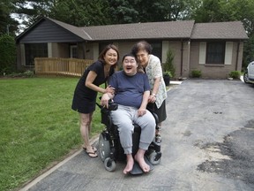 Alex Cha with his sister Jin Cha and mother Jeong Cha at his new home in London. (Derek Ruttan/The London Free Press)