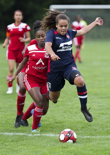 Ella Chase of Vaughn leaps ahead of Unionville Milliken's Cyerra Hibbert during their opening U15 soccer match at the 2018 Ontario Games in London. (Derek Ruttan/The London Free Press)