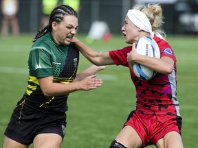 Kendra Cousineau of Niagara Rugby Union One (left) moves in to tackle Allison Stevenson of the Southwest Warriors  during their Ontario Summer Games rugby match at  Western University's Alumni Field in London, Ont. on Friday August 3, 2018. Niagara won the contest by a score of 21-15. Derek Ruttan/The London Free Press/Postmedia Network