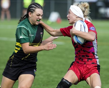 Kendra Cousineau of Niagara Rugby Union One (left) moves in to tackle Allison Stevenson of the Southwest Warriors  during their Ontario Summer Games rugby match at  Western University's Alumni Field in London, Ont. on Friday August 3, 2018. Niagara won the contest by a score of 21-15. Derek Ruttan/The London Free Press/Postmedia Network
