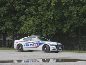 A police car is parked near the area where a body was discovered in the area of Wortley Road and Stanley Street in London. (Derek Ruttan/The London Free Press)