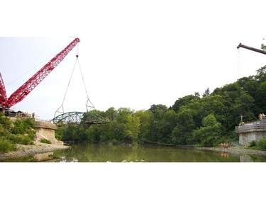 London's iconic Blackfriars Bridge begins its journey back into position across the north branch of the Thames River in London, Ont. on Wednesday August 15, 2018. An 800-tonne crane was used to move the stripped-down bridge into position before work to finish the structure continues. The bridge is expected to be open for traffic in November. Mike Hensen/The London Free Press/Postmedia Network