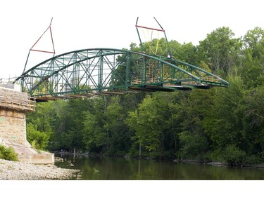 London's iconic Blackfriars Bridge begins its journey back into position across the north branch of the Thames River in London, Ont. on Wednesday August 15, 2018. An 800-tonne crane was used to move the stripped-down bridge into position before work to finish the structure continues. The bridge is expected to be open for traffic in November. Mike Hensen/The London Free Press/Postmedia Network