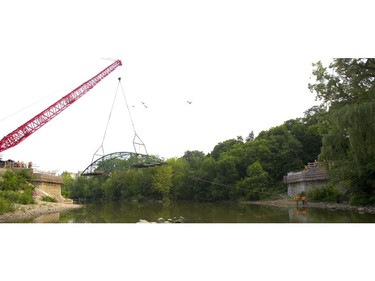 London's iconic Blackfriars Bridge begins its journey back into position across the north branch of the Thames River in London, Ont. on Wednesday August 15, 2018. An 800-tonne crane was used to move the stripped-down bridge into position before work to finish the structure continues. The bridge is expected to be open for traffic in November. Mike Hensen/The London Free Press/Postmedia Network