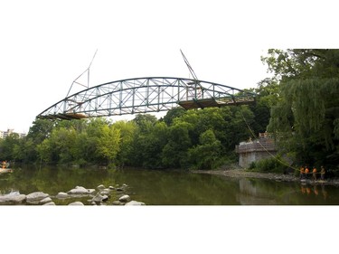 London's iconic Blackfriars Bridge is directed by ropes as it's rotated into a proper orientation before being lowered onto its rebuilt footings across the north branch of the Thames River in London, Ont. on Wednesday August 15, 2018. An 800-tonne crane was used to move the stripped-down bridge into position before work to finish the structure continues. The bridge is expected to be open for traffic in November. Mike Hensen/The London Free Press/Postmedia Network