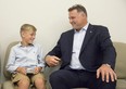 Eric Lindros  jokes with 11-year-old Sheldon Geerts prior to a press conference at Western University on Thursday.  Lindros announced the NHLPA Challenge raised $3.125 million for concussion research and Geerts spoke about his experiences with concussion. (Derek Ruttan/The London Free Press)