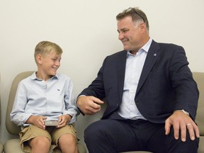 Eric Lindros  jokes with 11-year-old Sheldon Geerts prior to a press conference at Western University on Thursday.  Lindros announced the NHLPA Challenge raised $3.125 million for concussion research and Geerts spoke about his experiences with concussion. (Derek Ruttan/The London Free Press)