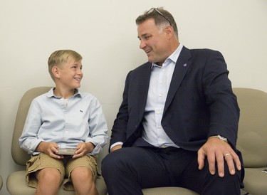 Former National Hockey League star Eric Lindros  jokes with 11-year-old Sheldon Geerts prior to a press conference at Western University Thursday.  Lindros announced the NHLPA Challenge raised $3.125 million for concussion research. (Derek Ruttan/The London Free Press)