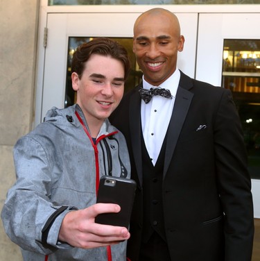 Ryan Taylor grabs a selfie with Damian Warner as Warner arrives for Logan Couture's All in for Brain Research charity casino night at Centennial Hall in London, Thursday.  Mike Hensen/The London Free Press/Postmedia Network
