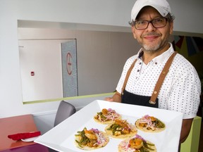 Marvin Rivas of Che shows off his shrimp creations. (Mike Hensen/The London Free Press)