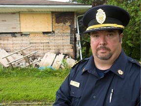 Acting deputy fire chief Jack Burt shows how a December butane THC-extraction blast blew the bricks off the walls of this Hamilton Road home. (Mike Hensen/The London Free Press)