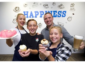 Olha Prytkova the owner of Happiness Bakery, shows off the goods with her husband Anatolii Prytkov and children Dan, 12, and Yeva, 11. Their bakery is on Wellington Street just north of Dundas Street. (Mike Hensen/The London Free Press)