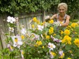 Master gardner Jo-Ann McIntyre tends to chores in the garden of her east London home. (Mike Hensen/The London Free Press)