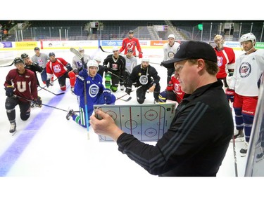 Danny Svyret, former captain of the 2005 London Knights, sketches out a drill for NHLers skating at Budweiser Gardens in London on Tuesday. Some of the notables were former Knights Corey Perry of Anaheim, Bo Horvat of Vancouver, Olli Maatta of the Penguins and Drew Doughty of the LA Kings. (Mike Hensen/The London Free Press)
