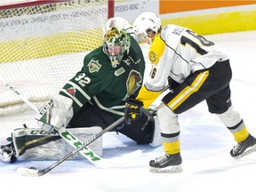 London Knights goaltender Joseph Raaymakers stops Sarnia Sting forward Theo Hill during an Ontario Hockey League preseason game at Budweiser Gardens Friday. (DEREK RUTTAN, The London Free Press)