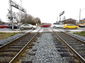 Automobiles travel across rail road tracks on Adelaide St. (File photo)