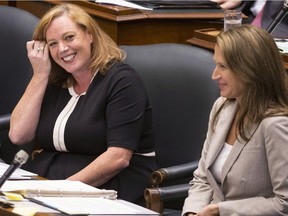 Lisa Macleod (left), Ontario's Children, Community and Social Services Minister sits with Attorney General Caroline Mulroney during Question Period at the Ontario Legislature Aug. 2.