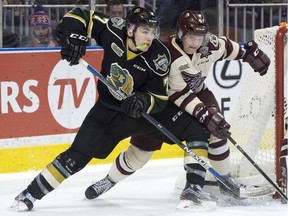 London Knights forward Matthew Tkachuk squeezes past Peterborough Petes defenceman Matthew Timms while attempting a wraparound shot on Petes goaltender Matthew Mancina during their OHL hockey game at Budweiser Gardens in London, Ont. on Friday January 22, 2016. (Free Press file photo)