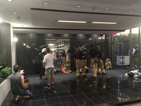 Some residents are gathered in the lobby waiting. Firefighters knocked on every apartment doors asking residents to leave. (SHANNON COULTER, The London Free Press)