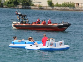 Participants in the St. Clair River float down head out into the river at the start of the last year's event. Canadian Coast Guard officials estimated 100 people left from the Canadian side. A larger group launched from the beach at the lighthouse on the Michigan side of the waterway. (Paul Morden/Sarnia Observer file photo)