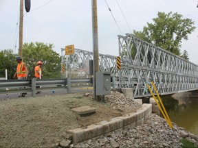 Crews work Wednesday afternoon on final touches on the single-lane temporary bridge in Port Bruce, which connects Bank Street and Dexter Line. The bridge is expected to be open to traffic Monday, ending the months-long wait for residents of the small community 25 kilometres southeast of St. Thomas. (LAURA BROADLEY, Times-Journal)