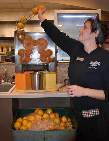 Meghan demonstrates how the Silver Grill Cafe in downtown Fort Collins produces such fresh orange juice.

BARBARA TAYLOR/THE LONDON FREE PRESS