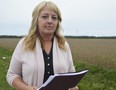 Kristen Rodrigues stands near the Cedar Point II Wind Energy Centre northeast of Sarnia, in operation since October 2015. With the end of the Green Energy Act Rodrigues and others have renewed their calls for stricter testing around turbines, testing they say is based on faulty regulations. (Louis Pin/The Observer)