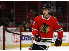 Adam Boqvist of the Chicago Blackhawks participates in warm-ups before a preseason game against the Detroit Red Wings at the United Center on September 25, 2018 in Chicago, Illinois.