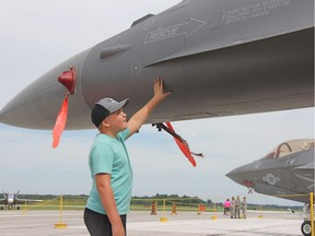 Ben Feddema, 11, admires an F-16 jet on Friday at Airshow London. (Jonathan Juha/The London Free Press)