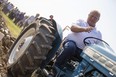 Ontario Premier Doug Ford sits on a Ford tractor as he plows a furrow at the International Plowing Match in Pain Court Ont. Tuesday, September 18, 2018. THE CANADIAN PRESS/ Geoff Robins ORG XMIT: GJR106