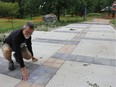 Don Clayton, a volunteer for the Terry Fox Foundation, shows the imprints in the concrete walk that mimic Terry Fox's gait, part of a new memorial to Fox at Greenway Park. The memorial and an image of Fox will be unveiled Sunday at noon. (JONATHAN JUHA, The London Free Press)