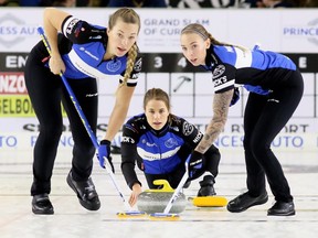 Skip Anna Hasselborg, of Sweden, throws a rock as second Agnes Knochenhauer, left, and lead Sofia Mabergs sweep during the women's final at the Grand Slam of Curling's Princess Auto Elite 10 tournament at Thames Campus Arena in Chatham, Ont., on Sunday, Sept. 30, 1018. (Mark Malone/Chatham Daily News)