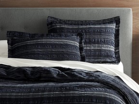 Crate & Barrel’s Nagano collection features lightweight cotton and linen voile bedding in a navy and white stitched pattern. (Crate & Barrel)