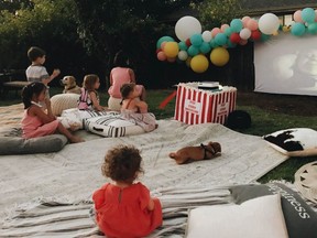 Children at a backyard birthday party watch the movie “Shrek” on an outdoor theatre setup in Concord, Calif. (Rozalyn Schlumpf/Wittybash.com via AP)