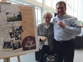 Barb Sadler, and her son Jeff, pose with some apples at the newly opened library branch at the Bostwick Community Centre. The Sadler family ran an apple orchard on the property for decades.