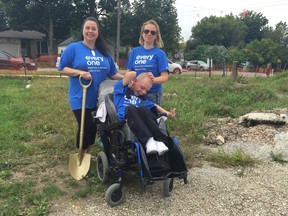 Jodey Delaney, left, 14-year-old Brayden and his mother Brianne Hibma break ground at the site of their two future Habitat for Humanity homes on Forbes Street Thursday. (Jennifer Bieman, The London Free Press)