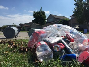Thurman Circle was strewn with garbage and empty bottles Tuesday following a large gathering on the street over the long weekend that resulted in revellers pelting a police cruiser with beer bottles. (Dale Carruthers / The London Free Press)