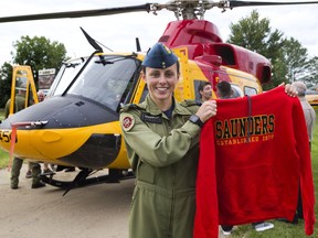 Royal Canadian Air Force Capt. Paula Findlater landed a search and rescue helicopter Thursday on the athletic track behind her alma mater, Saunders secondary school. The 26-year-old London native is now stationed at Canadian Forces Base Bagotville. She and her Griffon helicopter are here for Airshow London 2018. After landing she addressed pupils from Saunders, W. Sherwood Fox (her former elementary school) and Westmount elementary school. She was presented with this sweatshirt prior to her departure. (DEREK RUTTAN, The London Free Press)