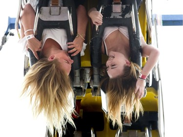 Alexandria Williamson and Kendra Mrakich of London ride the Ring Of Fire as the 143rd Western Fair. Lots of sunny, warm weather looms this week for fairgoers, according to Environment Canada. (DEREK RUTTAN, The London Free Press)