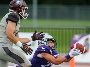 Western Mustangs safety Daniel Valente Jr. stretches out to make an interception in his end zone on a pass intended for McMaster slotback Dylan Astrom in Western's 44-6 home opening win over the Marauders in London, Ont. 
Photograph taken on Saturday September 8, 2018. 
Mike Hensen/The London Free Press/Postmedia Network