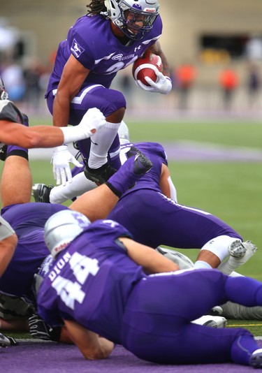 Western running back Cedric Joseph hurdles the line on his way to his first of three touchdowns Saturday in their home opener against the McMaster Marauders in London, Ont. 
Western won 44-6 on Saturday September 8, 2018. 
Mike Hensen/The London Free Press/Postmedia Network