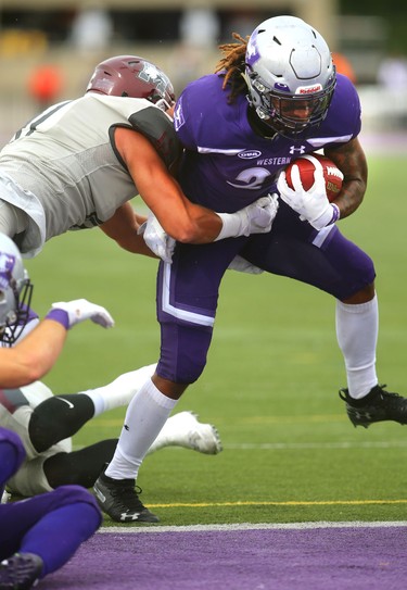 Western running back Cedric Joseph is hit by Mac linebacker Nate Edwards but too late to stop his first of three touchdowns Saturday in their home opener against the McMaster Marauders in London, Ont. 
Western won 44-6 on Saturday September 8, 2018. 
Mike Hensen/The London Free Press/Postmedia Network