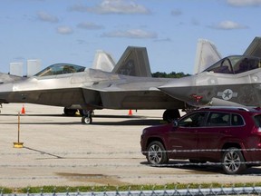 Two F-22 Raptors (left, middle) and an F-35 Lightning II wait on the tarmac at London airport after this weekend's airshow in London. Awaiting orders on where to go to avoid Hurricane Florence, the aircraft are undergoing routine maintenance under heavy security, an airshow spokesperson said. 
Mike Hensen/The London Free Press