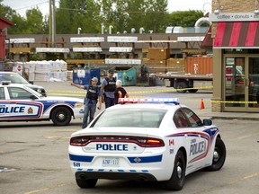 Police surround a Tim Hortons location on Dundas Street at Inudstrial Road after a man was shot and taken to hospital with injuries considered life threatening on Wednesday Sept. 12, 2018.  (Mike Hensen/The London Free Press)