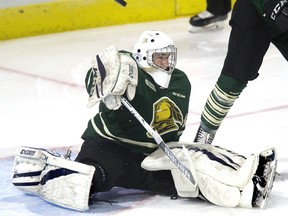 London Knights goalie Zachary Springer knocks away the puck with his blocker in the first period of their OHL preseason game against the Erie Otters  in London Friday. The Knights won 5-0.
Derek Ruttan/The London Free Press