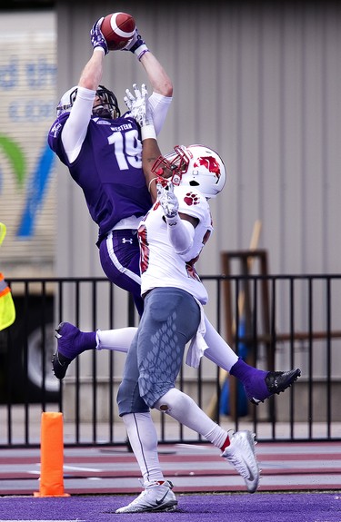 Western Mustang Harry McMaster leaps above Talik Ehouman of the York Lions to make an end zone reception and open the scoring of their football game at TD Stadium in London, Ont. on Saturday September 15, 2018. The Mustangs won the game by a score of 76-3. Derek Ruttan/The London Free Press/Postmedia Network