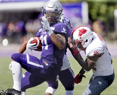 Western Mustang Cedric Joseph spins away from Kadeem Thomas of the York Lions during their football game at TD Stadium in London, Ont. on Saturday September 15, 2018. The Mustangs won the game by a score of 76-3. Derek Ruttan/The London Free Press/Postmedia Network