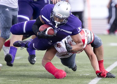 Western Mustang Trey Humes is brought down by Tevin McCarty of the York Lions during their football game at TD Stadium in London, Ont. on Saturday September 15, 2018. The Mustangs won the game by a score of 76-3. Derek Ruttan/The London Free Press/Postmedia Network